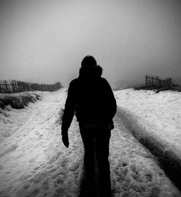 alternative rock artist walking into distant landscape